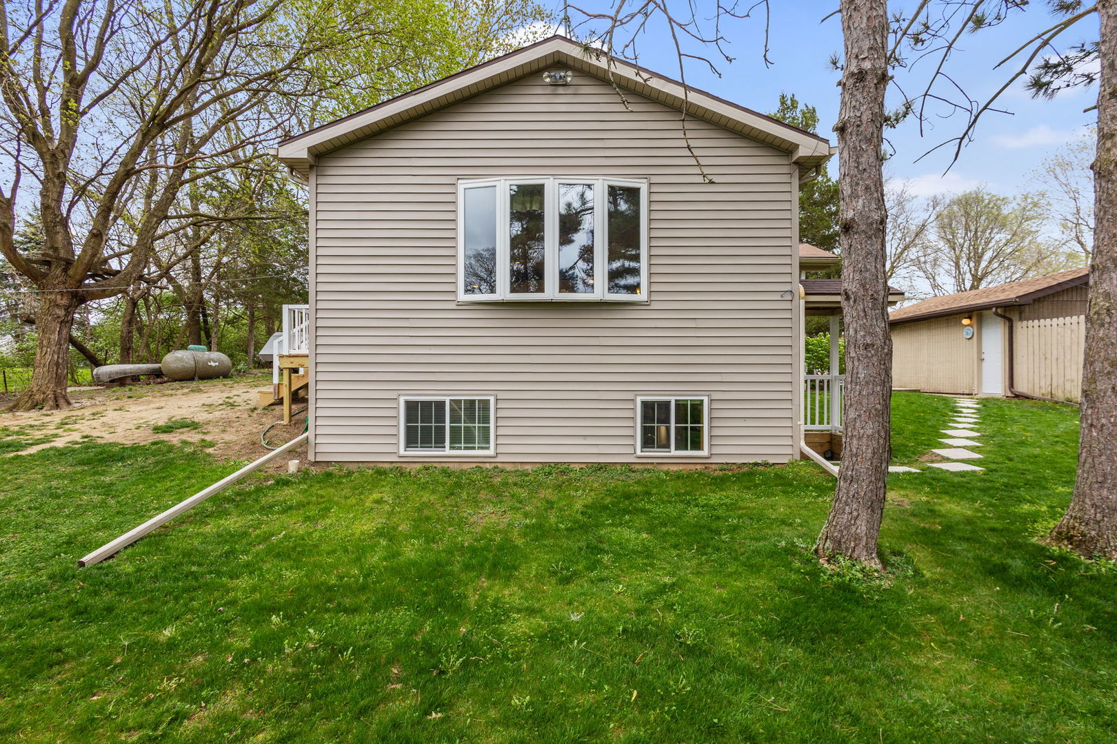 7134 North Bull Creek Road Grant Park, IL 60940 - Photo 6 of 46 a front view of a house with garden