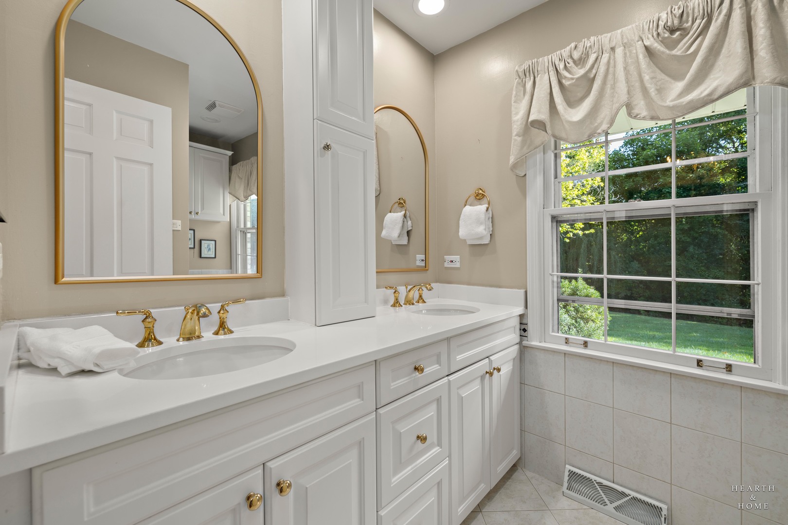 315 Old Mill Road Barrington, IL 60010 - Photo 23 of 37 a bathroom with a double vanity sink and a mirror