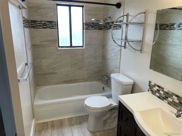 a bathroom with a sink toilet and shower