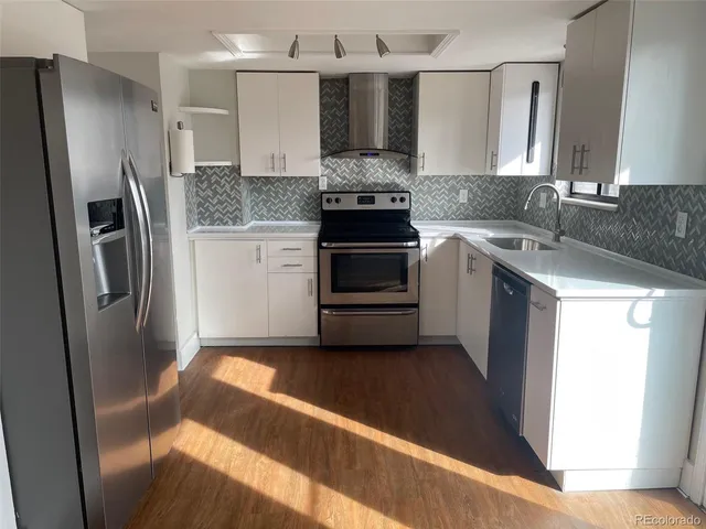 a kitchen with a refrigerator and a sink