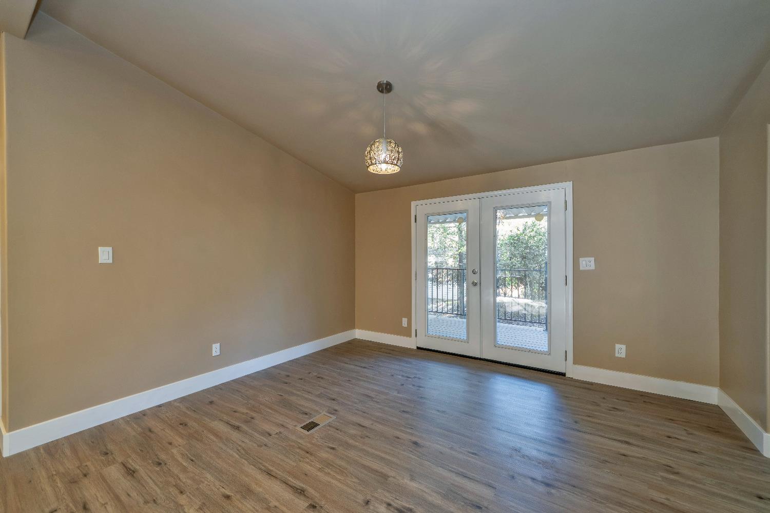 4420 Pleasant Valley Road, Unit 155 Diamond Springs, CA 95619 - Photo 20 of 42 a view of an empty room with wooden floor and a window