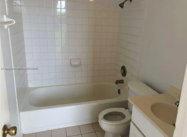 a bathroom with a bathtub and a toilet