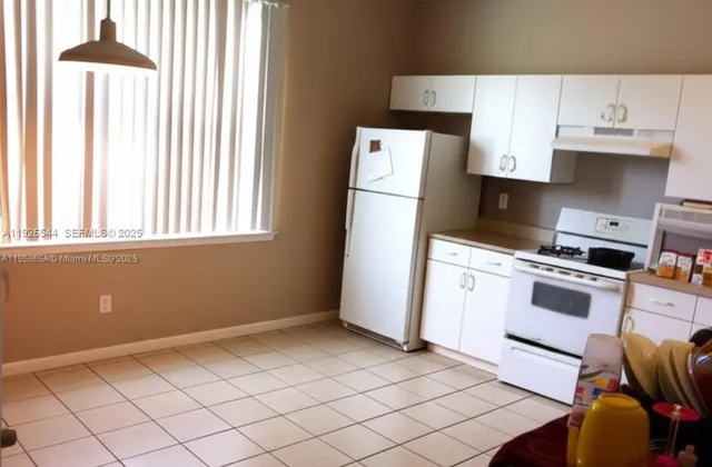 a kitchen with a stove a refrigerator and a sink