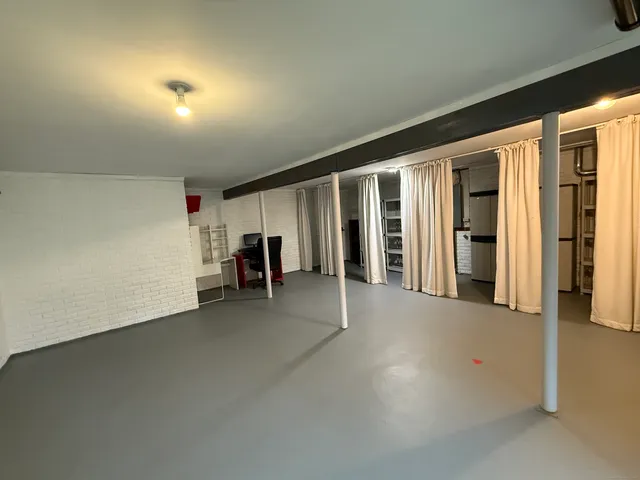 an empty room with furniture and a window