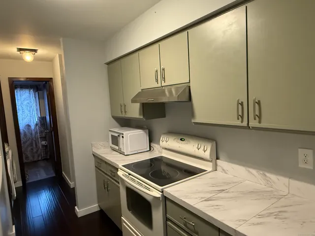 a kitchen with a stove and a microwave