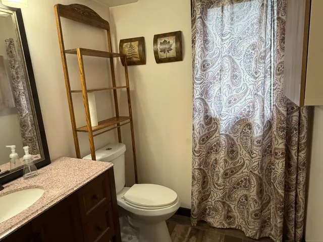 a bathroom with a sink toilet and shower