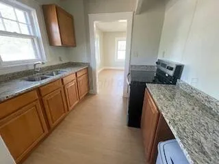 a kitchen with a sink stove and cabinets
