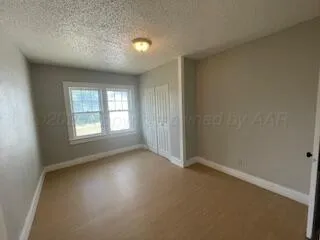 an empty room with windows and closet