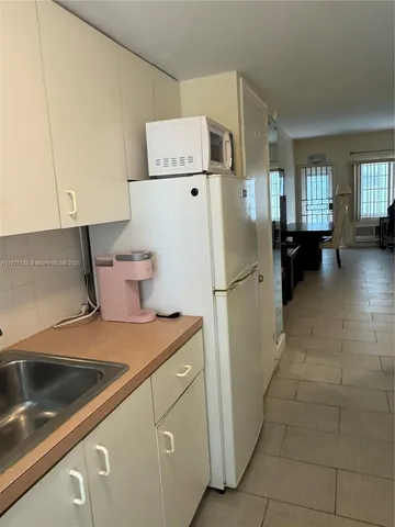 a kitchen with a refrigerator and a stove
