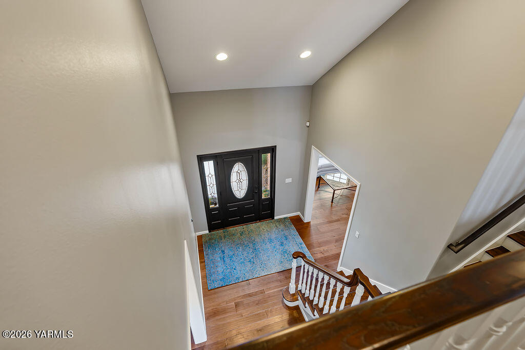 6810 Ravens Gate Way Yakima, WA 98908 - Photo 24 of 49 a view of a hallway with wooden floor and a potted plant