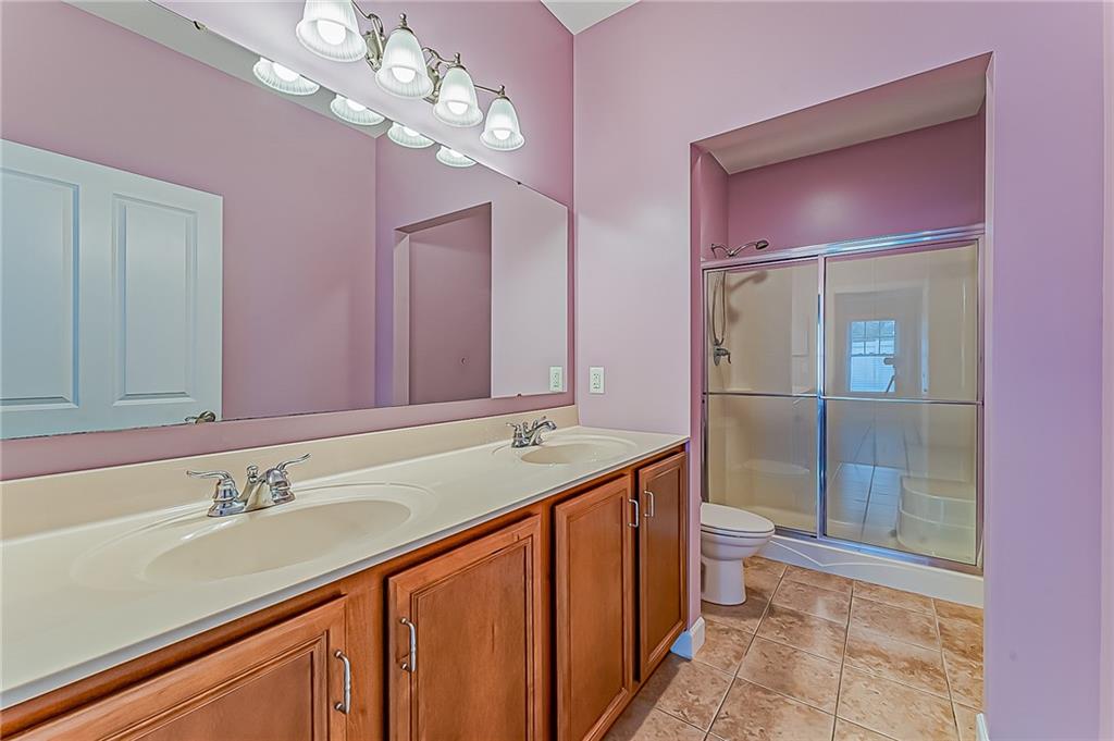 230 Berkeley Way, Unit B Monroeville, PA 15146 - Photo 15 of 25 a bathroom with a granite countertop sink a toilet a mirror and shower