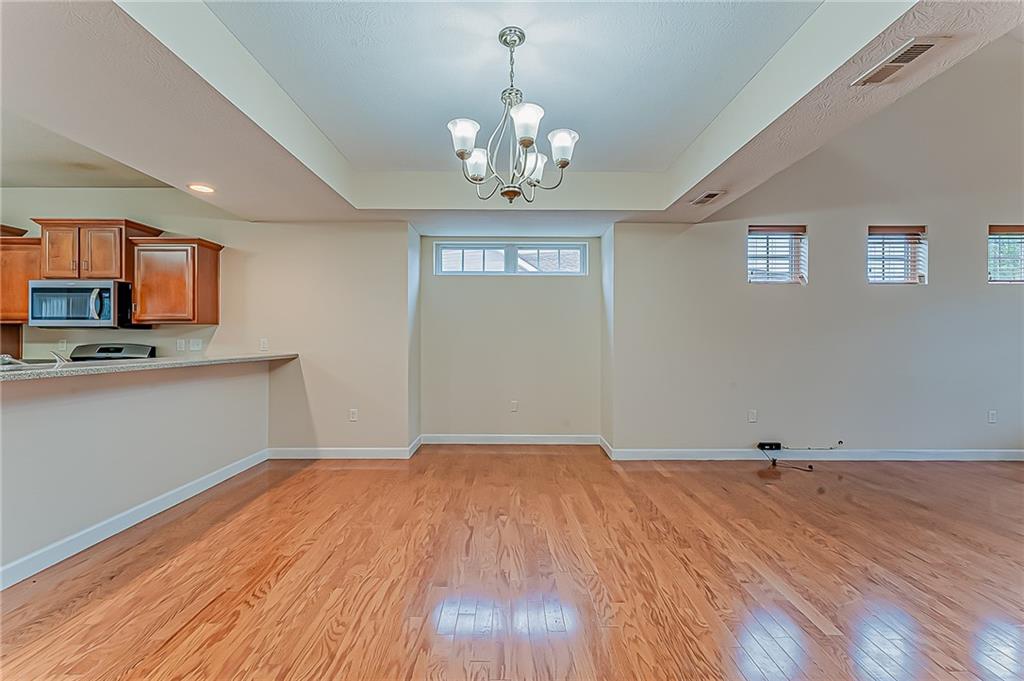 230 Berkeley Way, Unit B Monroeville, PA 15146 - Photo 4 of 25 a view of a kitchen with wooden floor and a sink