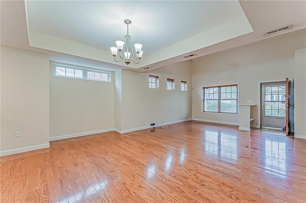 230 Berkeley Way, Unit B Monroeville, PA 15146 - Photo 5 of 25 a view of an empty room with wooden floor and a window