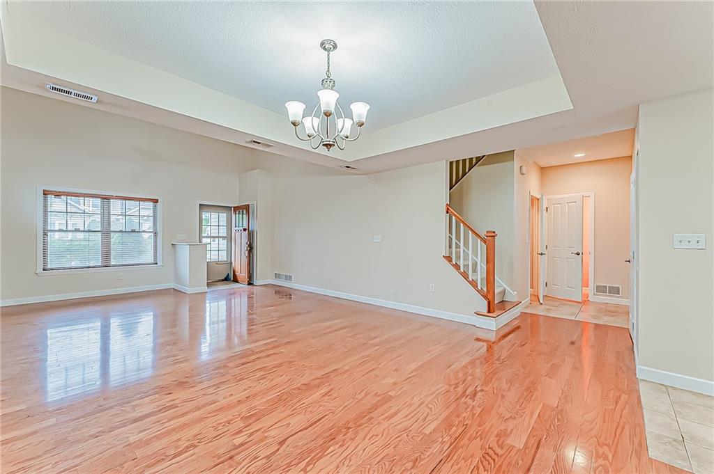 230 Berkeley Way, Unit B Monroeville, PA 15146 - Photo 6 of 25 a view of an empty room with wooden floor and a window