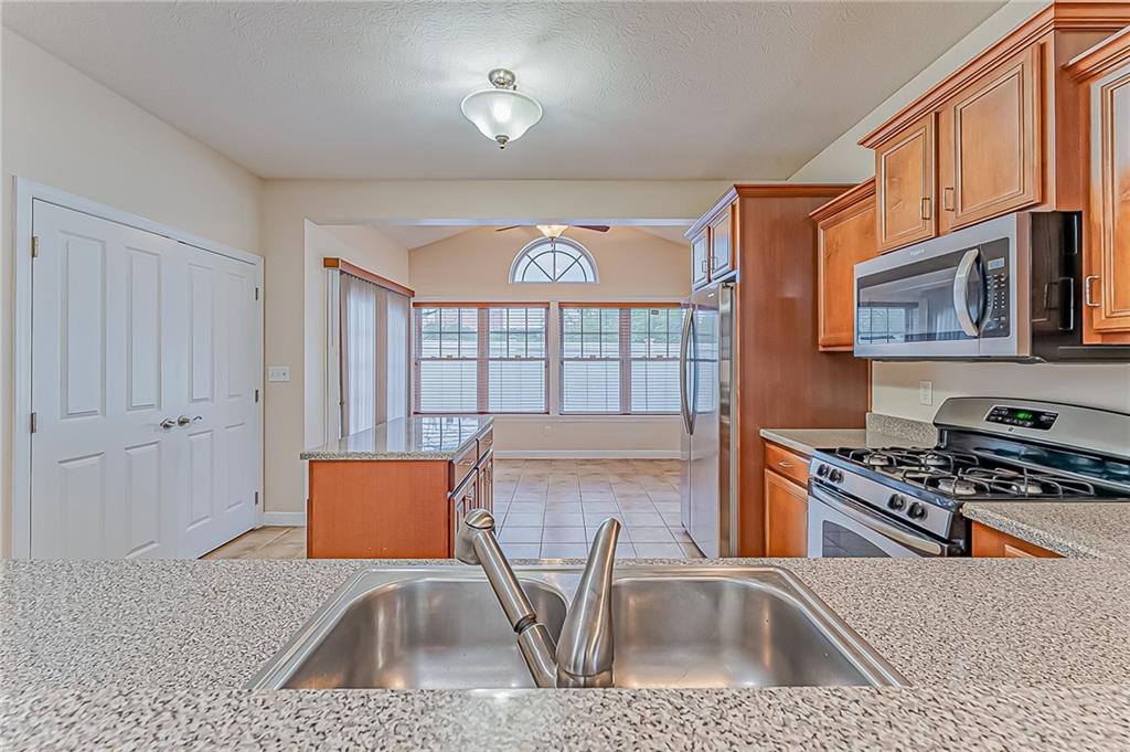 230 Berkeley Way, Unit B Monroeville, PA 15146 - Photo 7 of 25 a kitchen with stainless steel appliances granite countertop a sink stove and cabinets