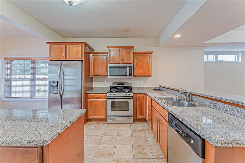 230 Berkeley Way, Unit B Monroeville, PA 15146 - Photo 8 of 25 a kitchen with stainless steel appliances granite countertop a sink stove and refrigerator
