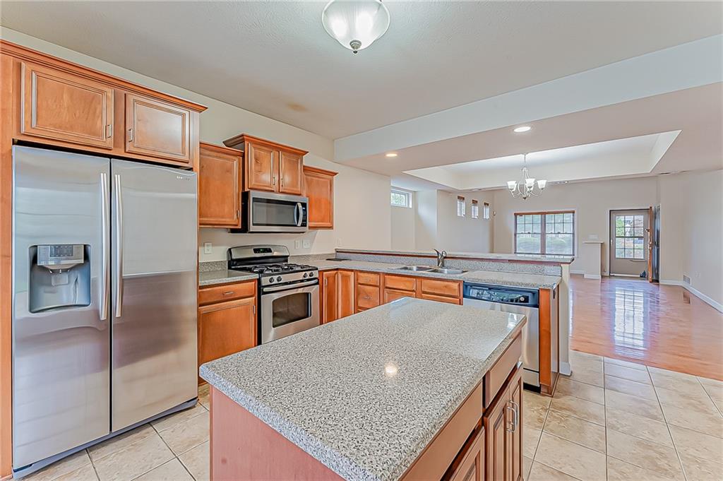 230 Berkeley Way, Unit B Monroeville, PA 15146 - Photo 9 of 25 a kitchen with stainless steel appliances granite countertop a refrigerator a stove top oven and a sink