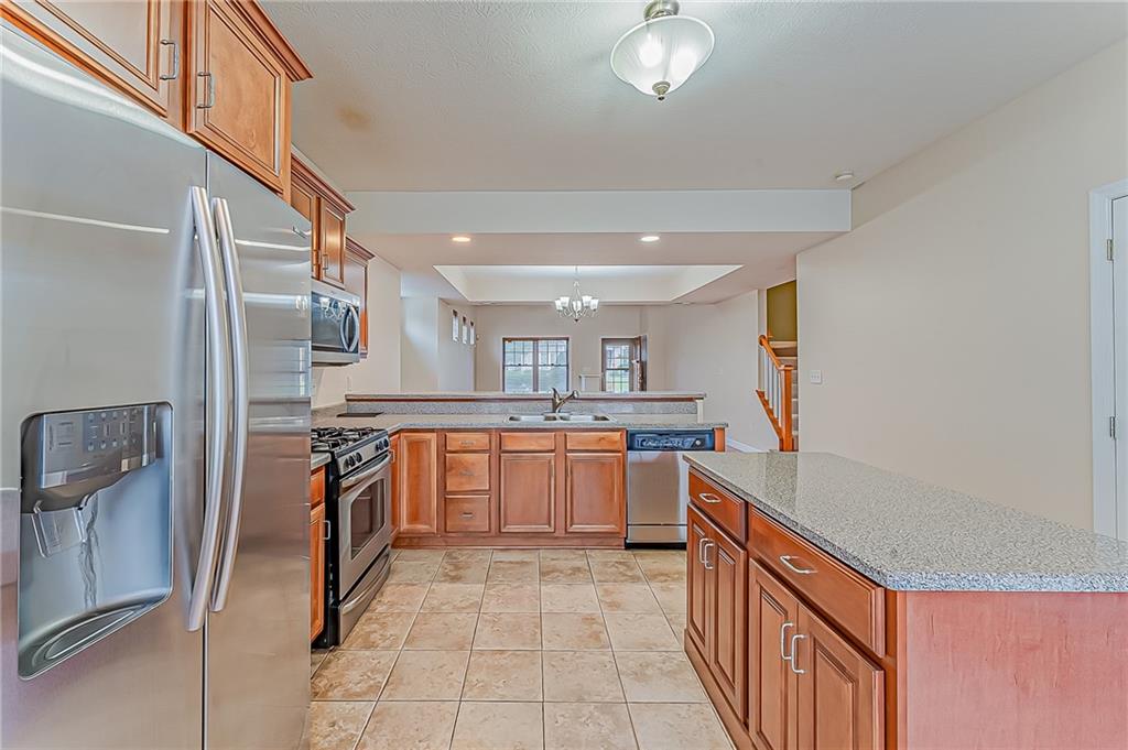 230 Berkeley Way, Unit B Monroeville, PA 15146 - Photo 10 of 25 a kitchen with stainless steel appliances granite countertop a refrigerator and a stove top oven