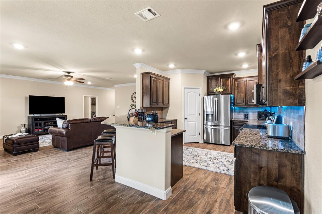 223 Cottongame Road Weatherford, TX 76088 - Photo 14 of 35 a living room with stainless steel appliances furniture and a flat screen tv