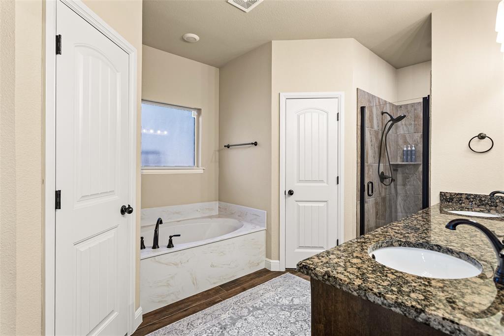 223 Cottongame Road Weatherford, TX 76088 - Photo 18 of 35 a bathroom with a tub sink and mirror