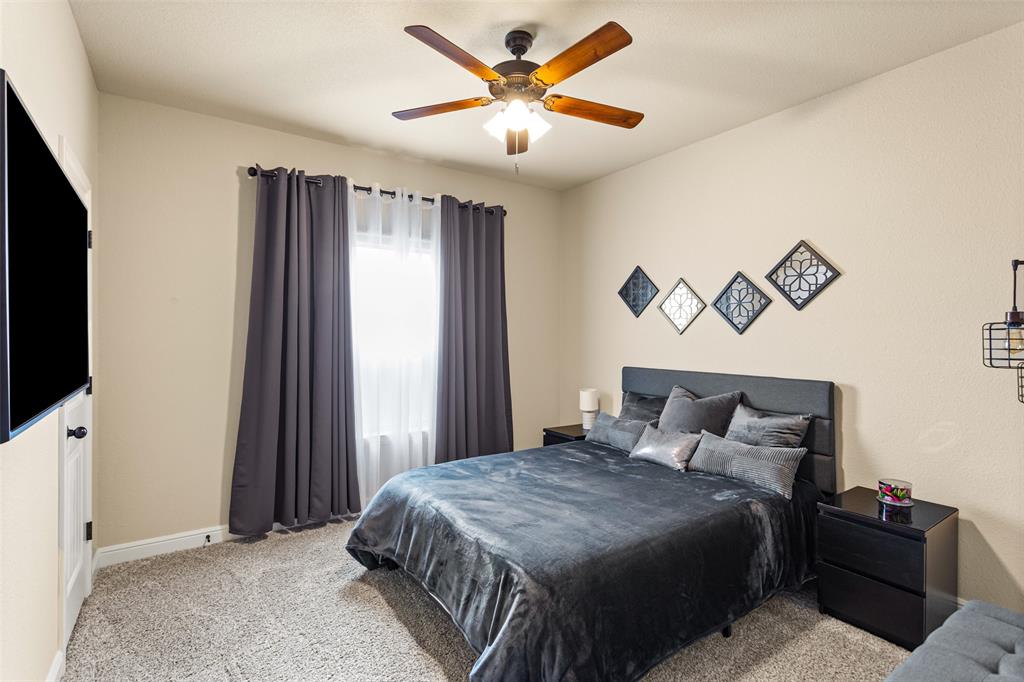 223 Cottongame Road Weatherford, TX 76088 - Photo 21 of 35 a bedroom with a bed and a flat screen tv