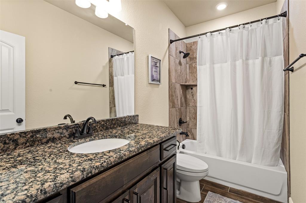 223 Cottongame Road Weatherford, TX 76088 - Photo 22 of 35 a bathroom with a granite countertop sink toilet and shower