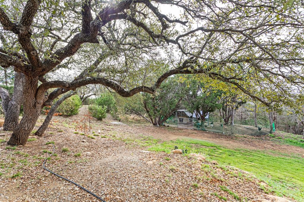 223 Cottongame Road Weatherford, TX 76088 - Photo 32 of 35 a backyard of a house with table and chairs