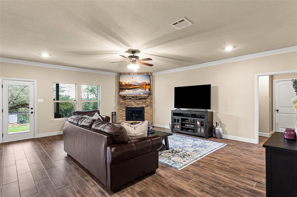 223 Cottongame Road Weatherford, TX 76088 - Photo 34 of 35 a living room with furniture and a flat screen tv