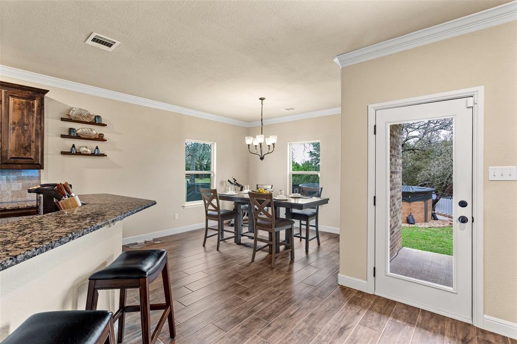223 Cottongame Road Weatherford, TX 76088 - Photo 9 of 35 a dining room with furniture window wooden floor