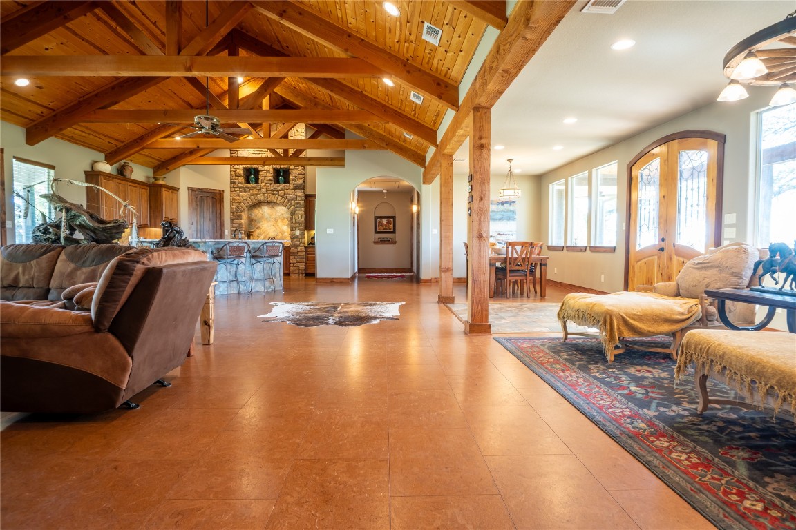 5525 Fm2340 Road Burnet, TX 78611 - Photo 16 of 39 Living area with a wooden ceiling with exposed beams, plenty of natural light, arched walkways, a ceiling fan, and high vaulted ceiling