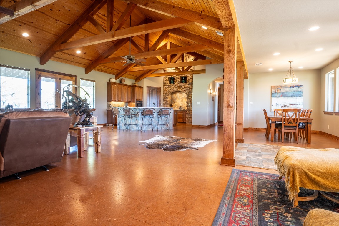 5525 Fm2340 Road Burnet, TX 78611 - Photo 3 of 39 Living room with plenty of natural light, arched walkways, a wooden ceiling with exposed beams, high vaulted ceiling, and ceiling fan