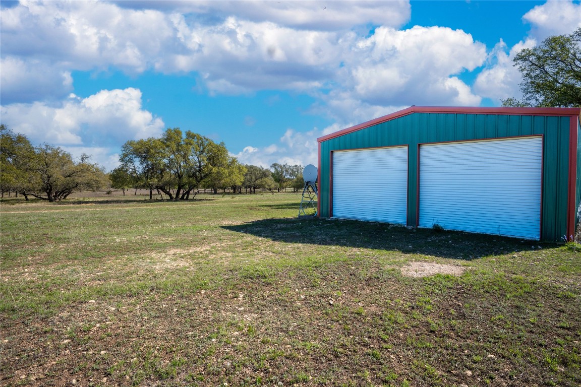 5525 Fm2340 Road Burnet, TX 78611 - Photo 37 of 39 View of grassy yard featuring an outdoor structure and a detached garage