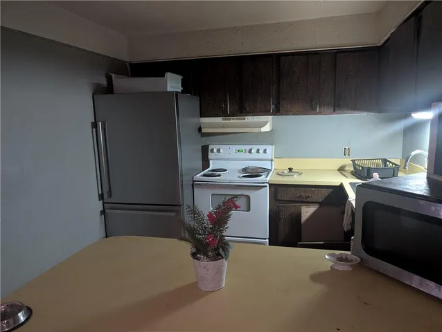 a utility room with cabinets washer and dryer