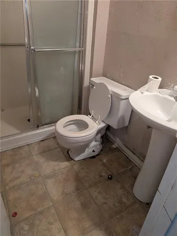 a bathroom with a toilet sink and shower