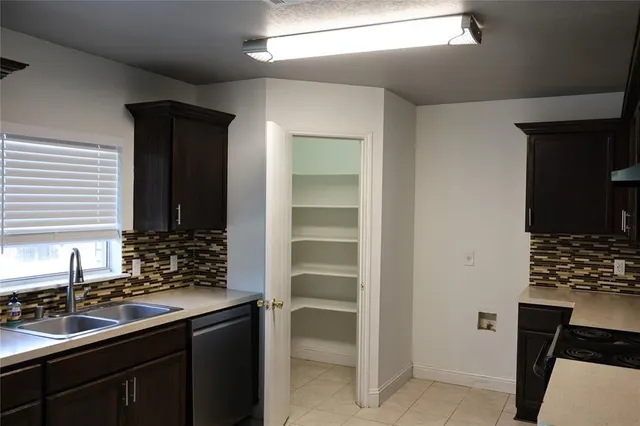 a kitchen with a sink and cabinets