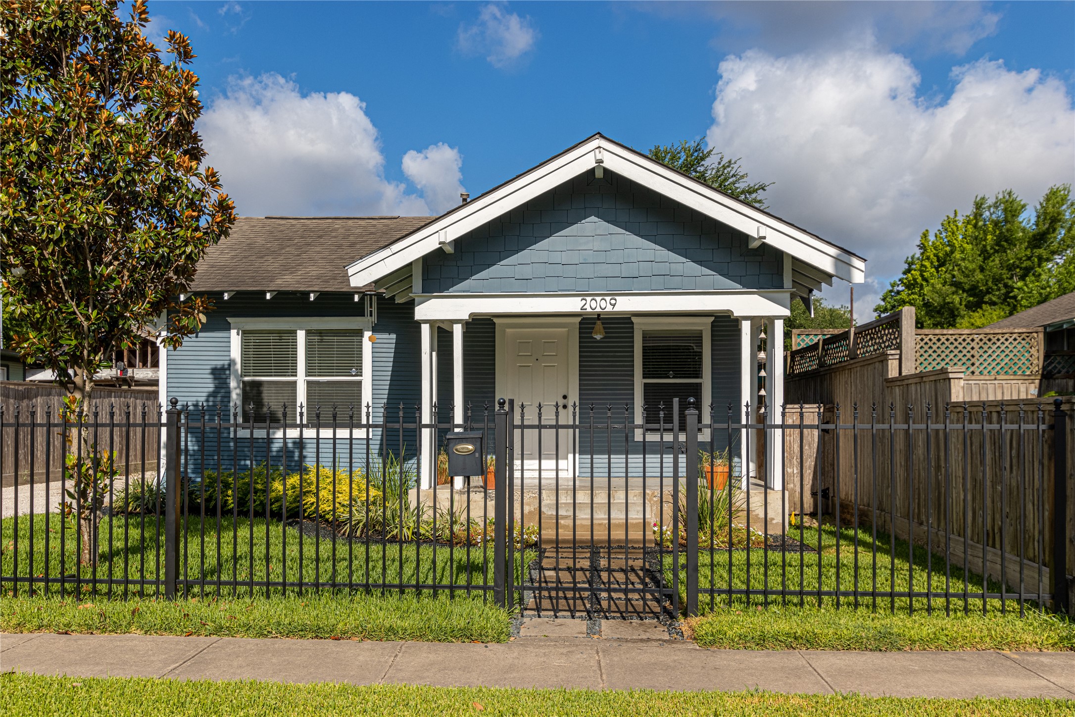 a front view of a house with a garden