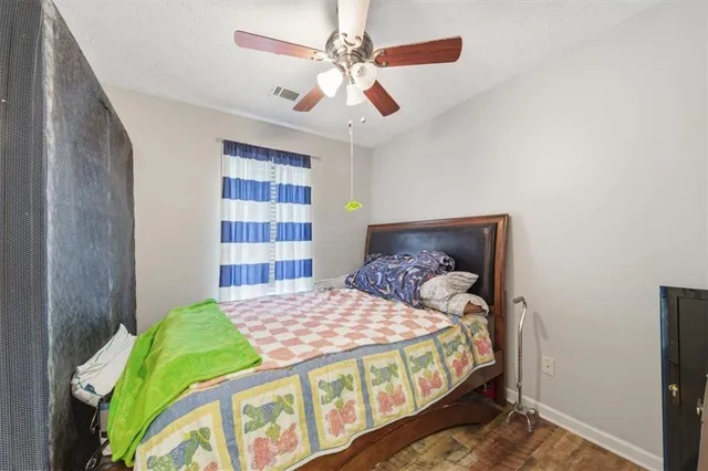 a bedroom with a bed and a book shelf