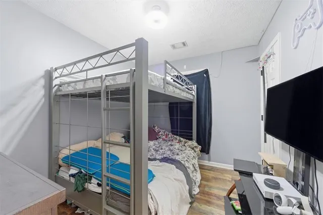 a bedroom with furniture and a flat screen tv