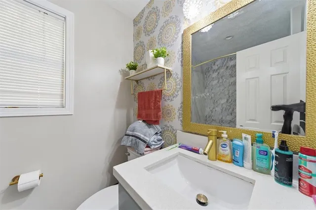 a bathroom with a sink a toilet and a shower