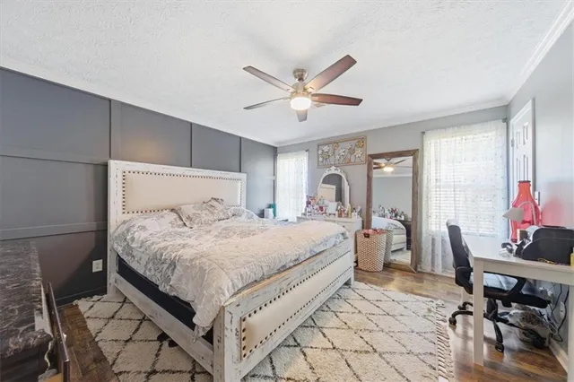 a bedroom with a bed dresser and a window