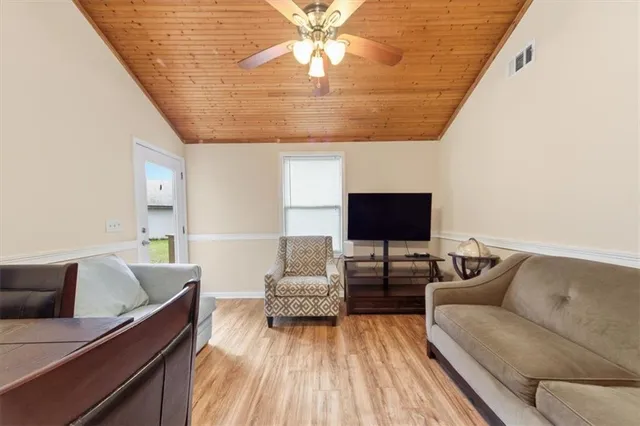 a living room with furniture and kitchen view