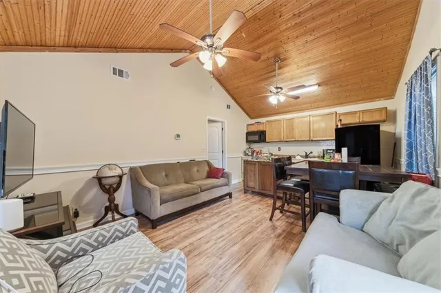 a kitchen with granite countertop lots of clutter and stainless steel appliances