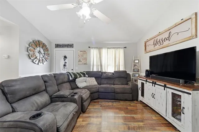 a living room with furniture and a flat screen tv