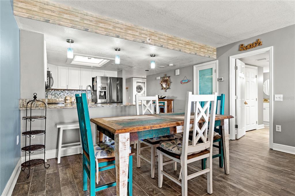 6035 Sea Ranch Drive, Unit 415 Hudson, FL 34667 - Photo 13 of 49 a view of a dining room with furniture and wooden floor
