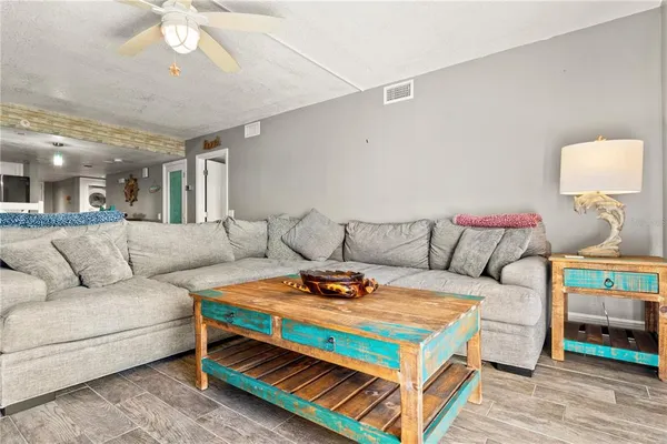 a living room with furniture and a chandelier