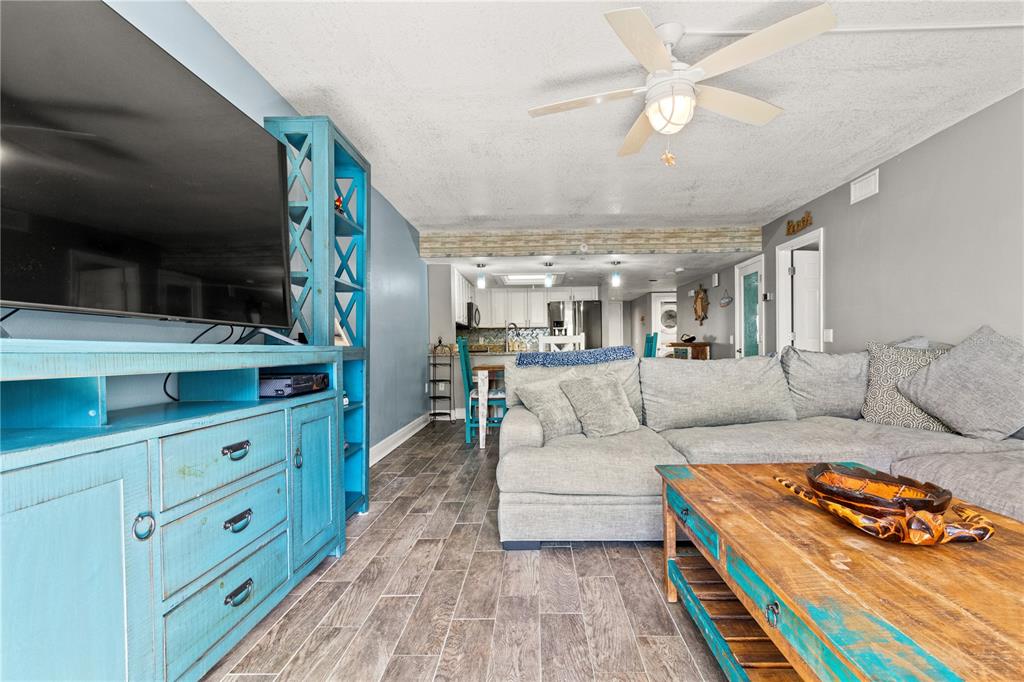 6035 Sea Ranch Drive, Unit 415 Hudson, FL 34667 - Photo 15 of 49 a living room with furniture and a chandelier