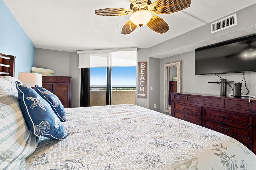 6035 Sea Ranch Drive, Unit 415 Hudson, FL 34667 - Photo 21 of 49 a bedroom with a bed and a flat screen tv