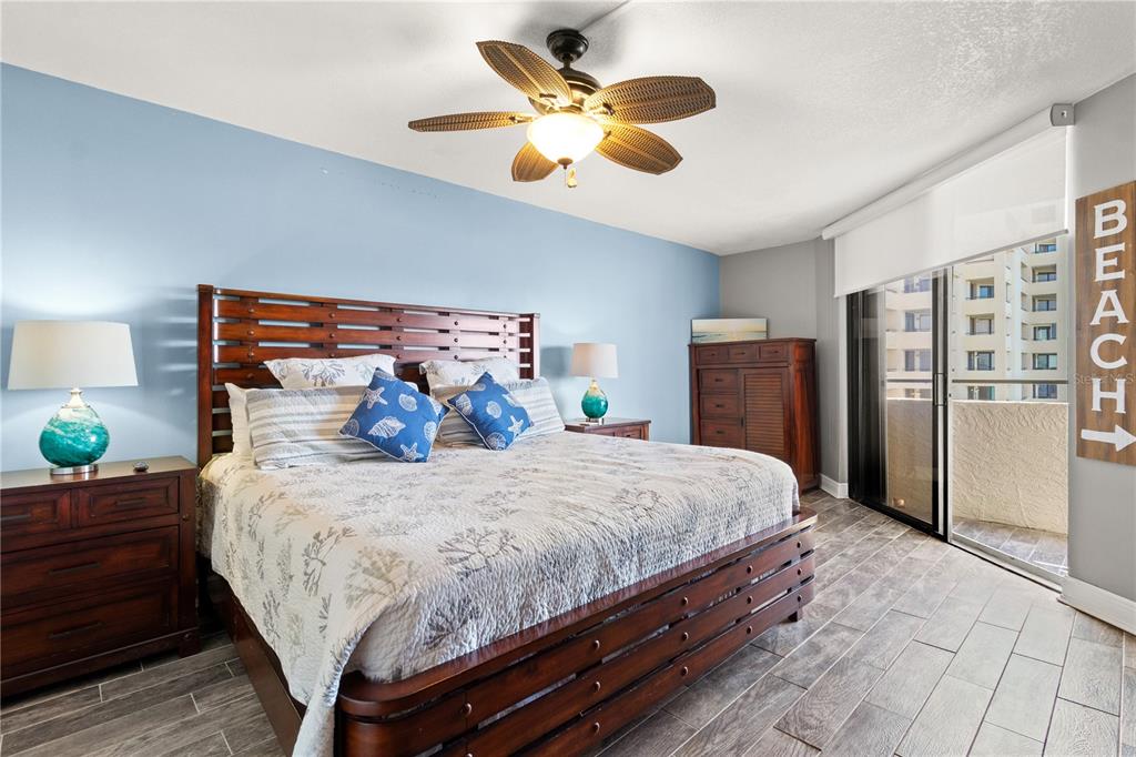 6035 Sea Ranch Drive, Unit 415 Hudson, FL 34667 - Photo 22 of 49 a bedroom with bed and wooden floor