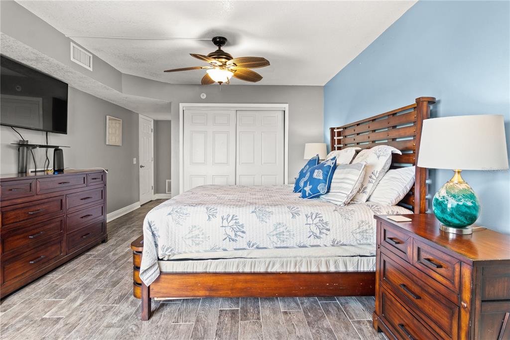 6035 Sea Ranch Drive, Unit 415 Hudson, FL 34667 - Photo 23 of 49 a bedroom with a bed and a flat screen tv