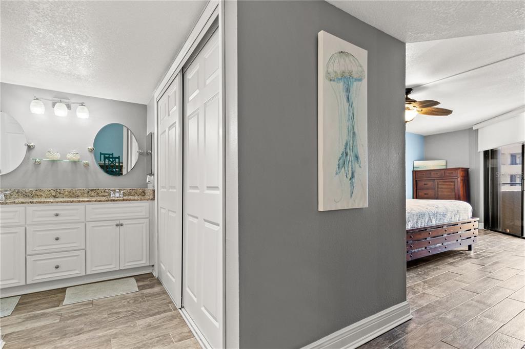 6035 Sea Ranch Drive, Unit 415 Hudson, FL 34667 - Photo 24 of 49 a en suite bathroom with a granite countertop sink and a mirror